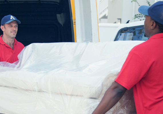 movers moving couch into moving truck
